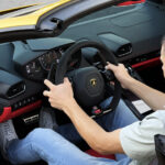 Rented Lamborghini Huracan Evo Spyder Convertible driving buy a customer in Dubai