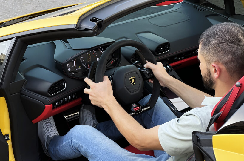 Rented Lamborghini Huracan Evo Spyder Convertible driving buy a customer in Dubai