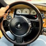 Rent Rolls-Royce Ghost in Dubai Steering holding image