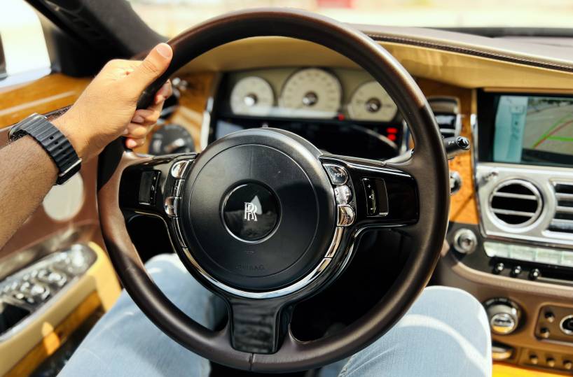 Rent Rolls-Royce Ghost in Dubai Steering holding image